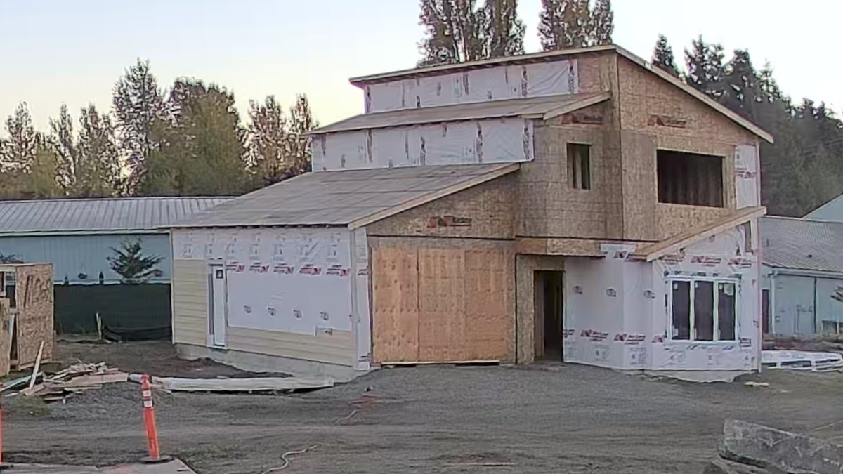 The Stratton under construction at 3920 San Juan Avenue, Port Townsend, WA: windows, siding and garage exterior door going in